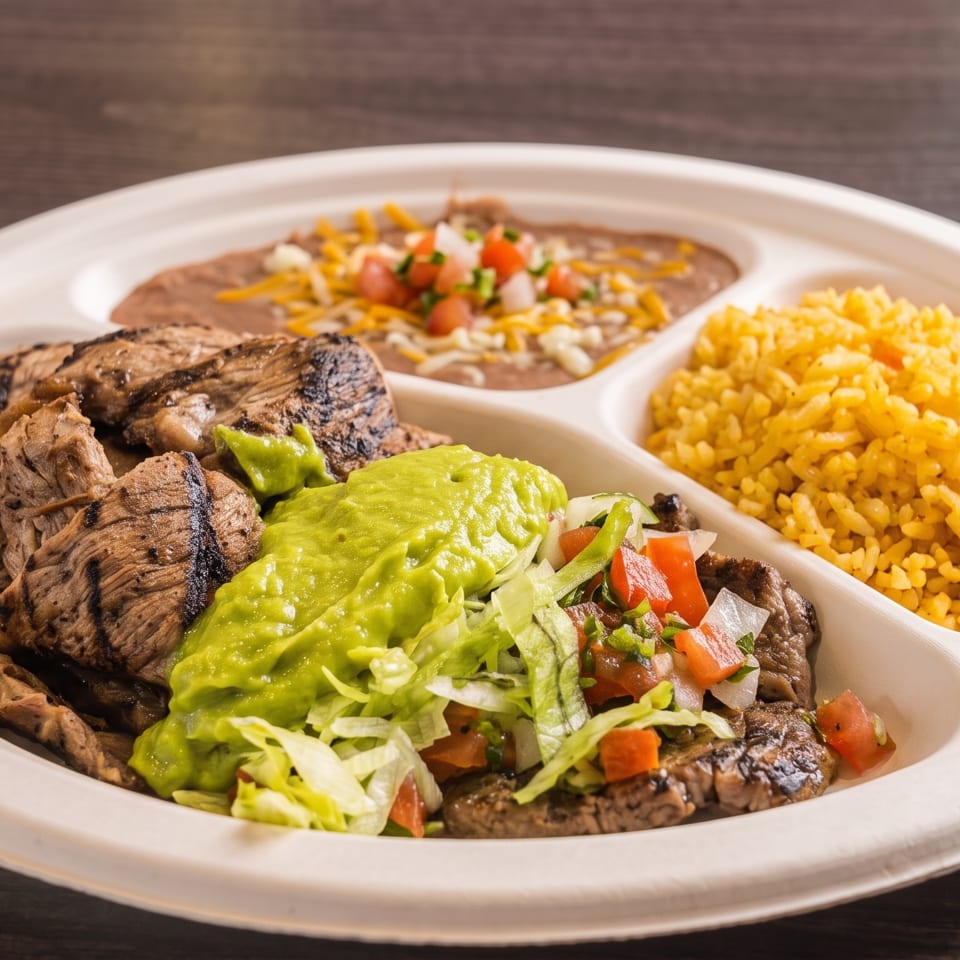 Grilled steak with guacamole, pico de gallo, rice, and refried beans on a divided plate.